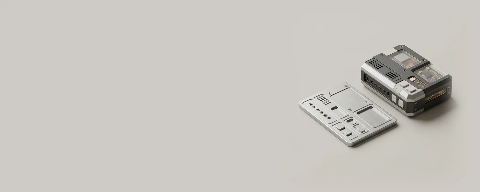 Studio render of a small device beside an etched metal plate whose raised shapes mirror its own ports and buttons