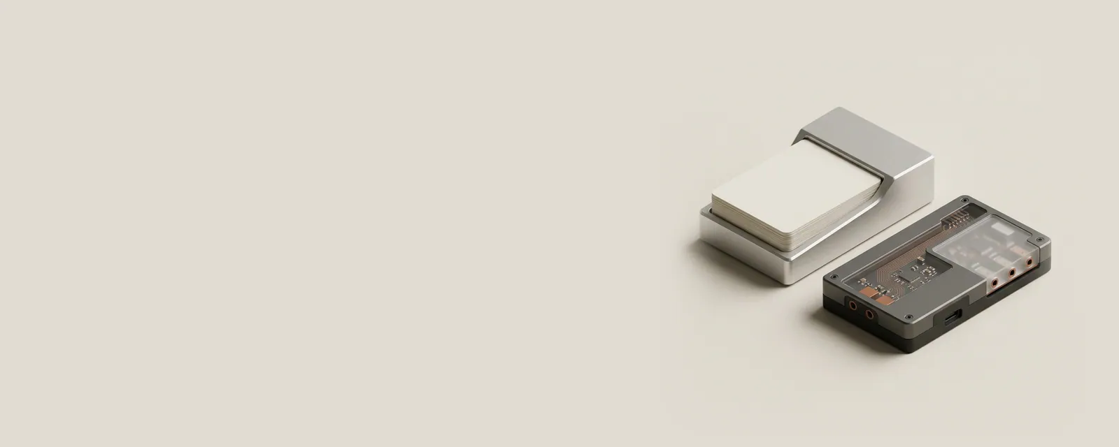 Studio render of a minimal aluminium desk calendar block with blank flip cards beside a small sound card