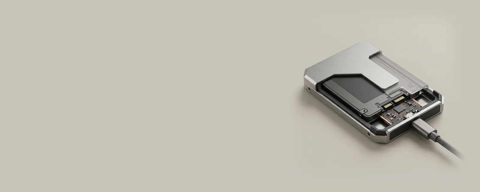 Studio render of a cutaway aluminium external enclosure showing a drive inside and a small bridge chip between the drive and a USB-C cable