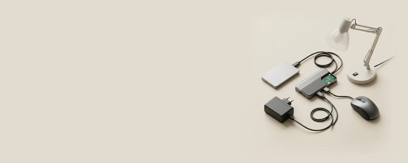 Studio render of a USB hub with three cables of different gauges leading to an SSD, a desk lamp and a mouse, a power adapter connected